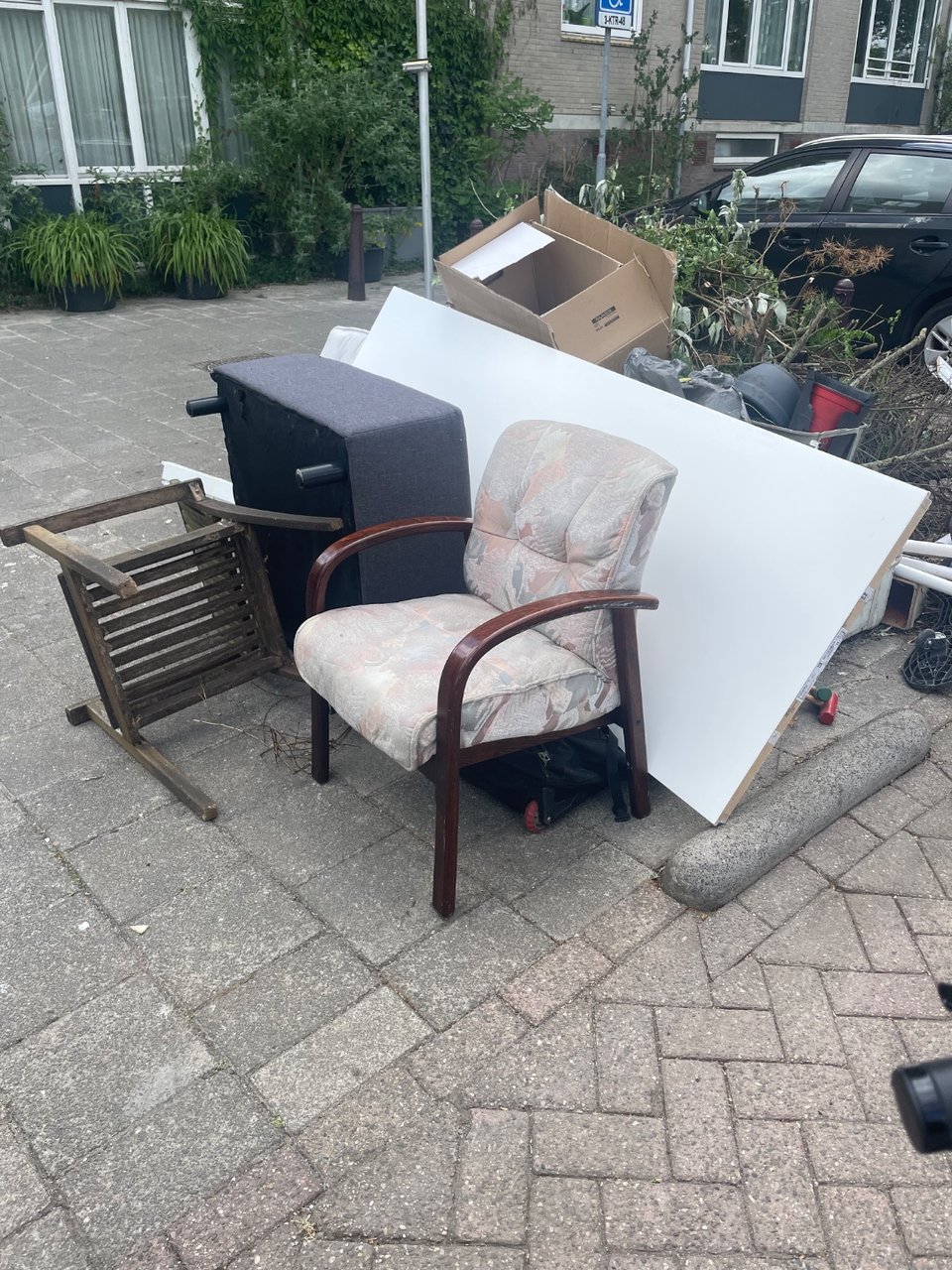 Indoor chair, outdoor chair, door and a nice wooden box that needs some love