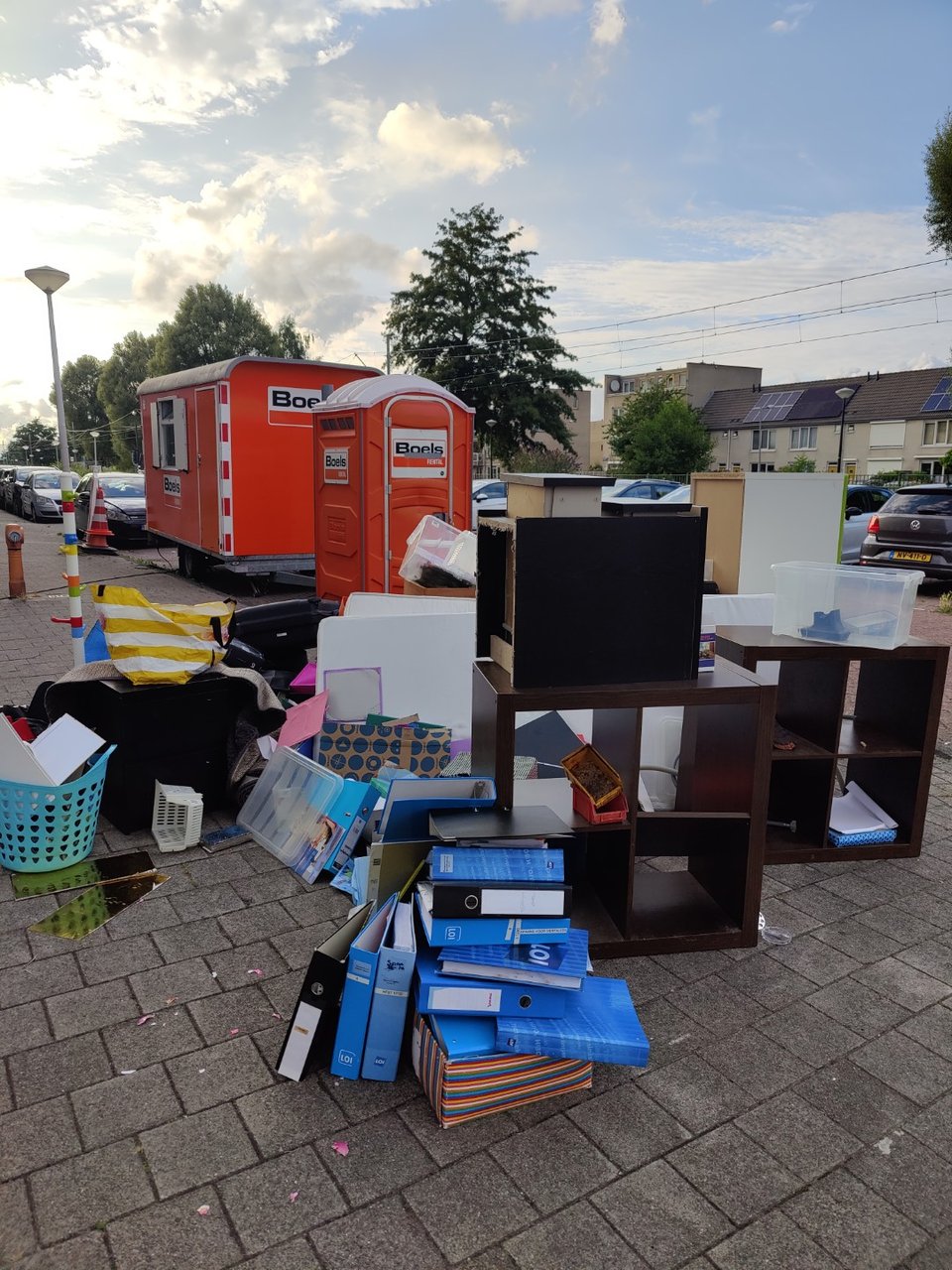 Ikea bookcases in different sizes and colors. Baskets and children stuff.