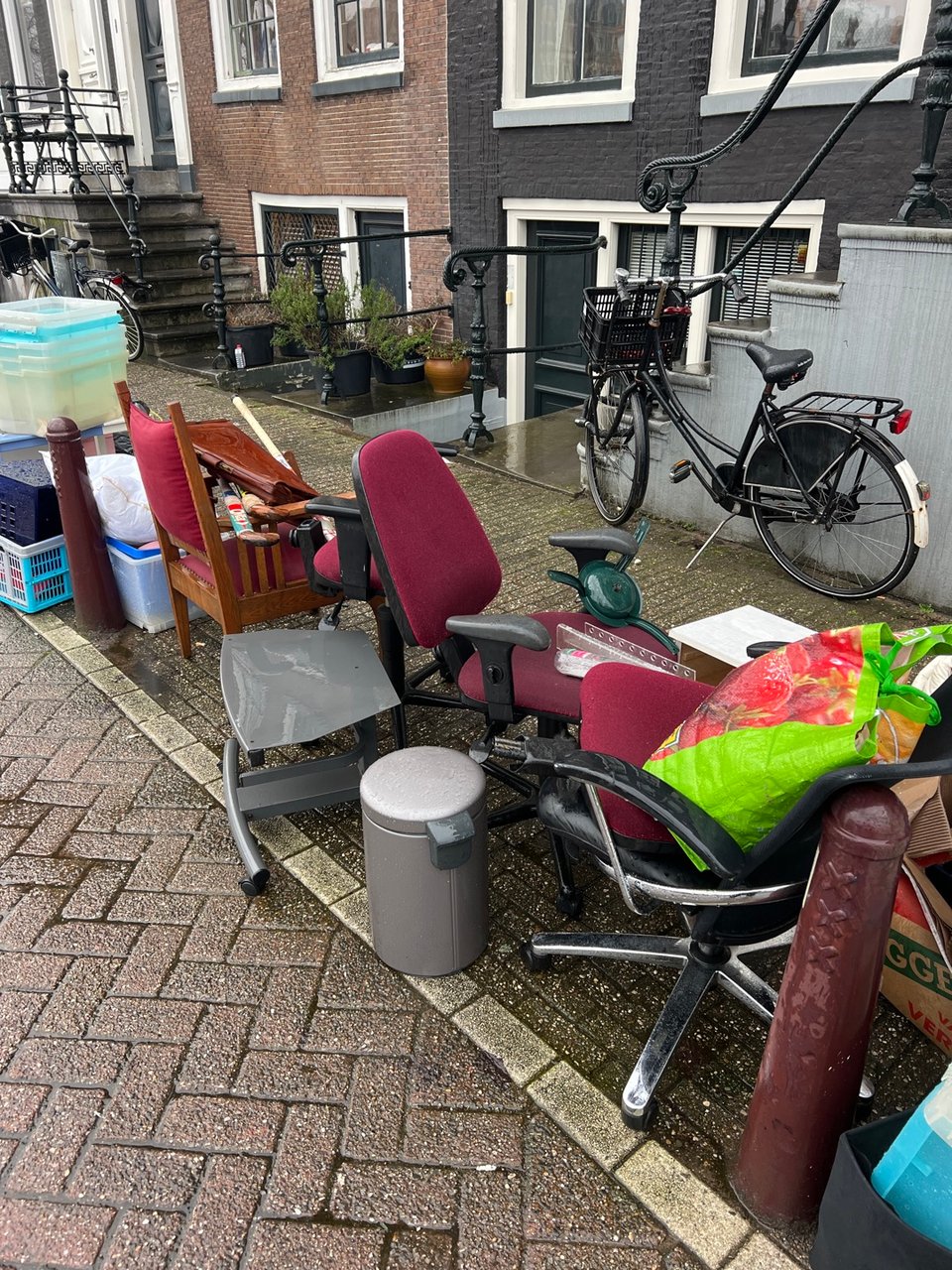 Some chairs, briefcase, hockey sticks