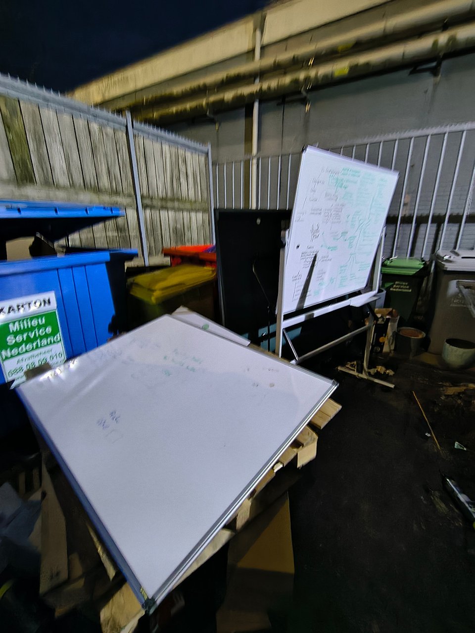 A couple of whiteboards and a few empty flowerpots.