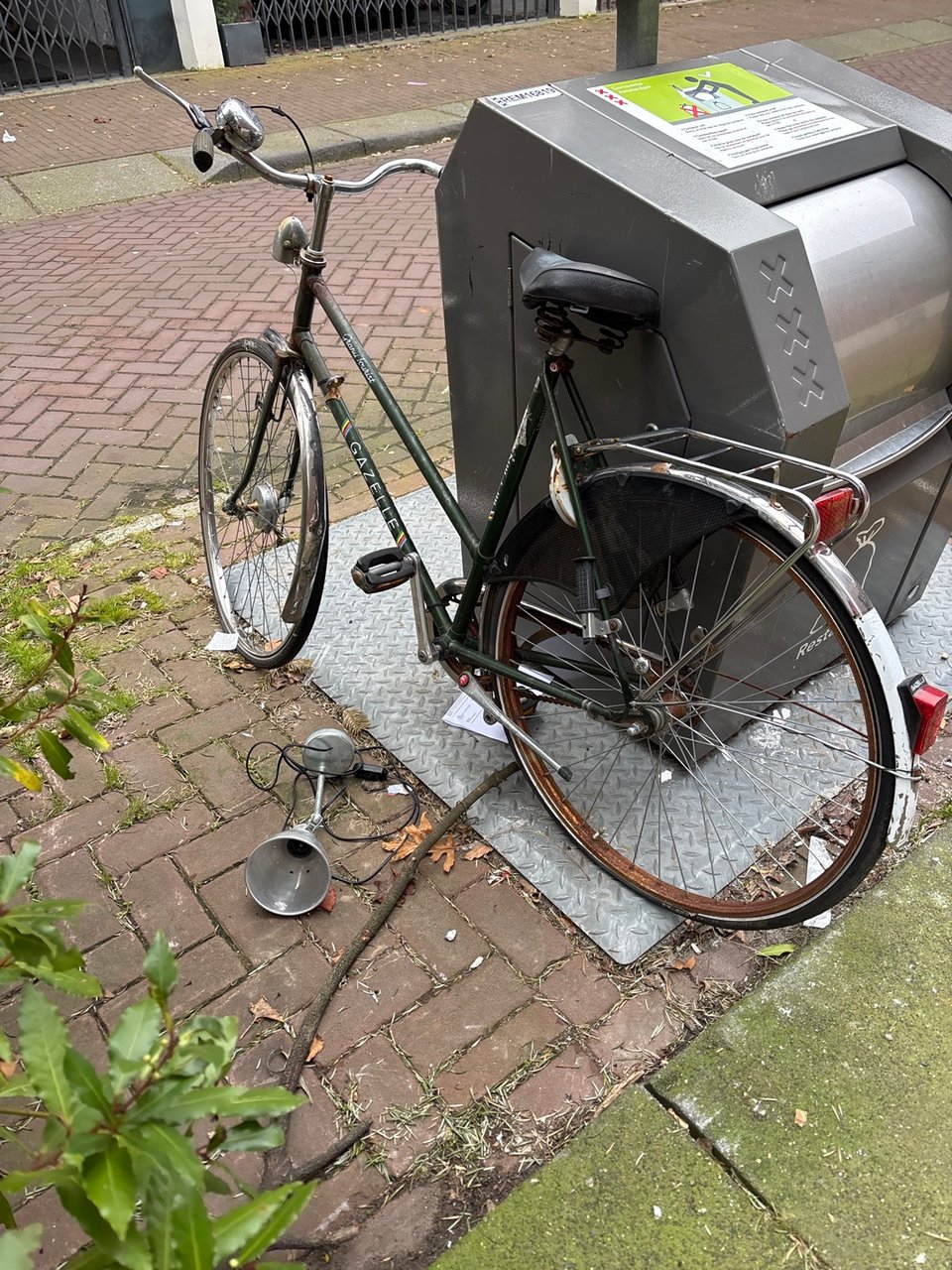 Gazelle bike, a bit beaten up and locked, but free