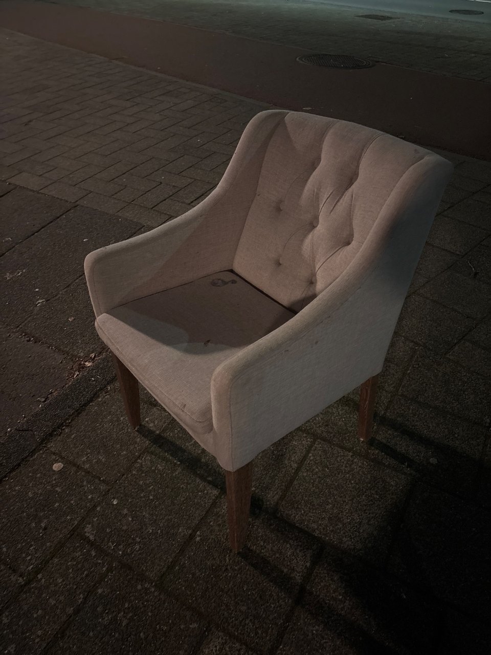 Chair, seems functional, fabric shows some stains.