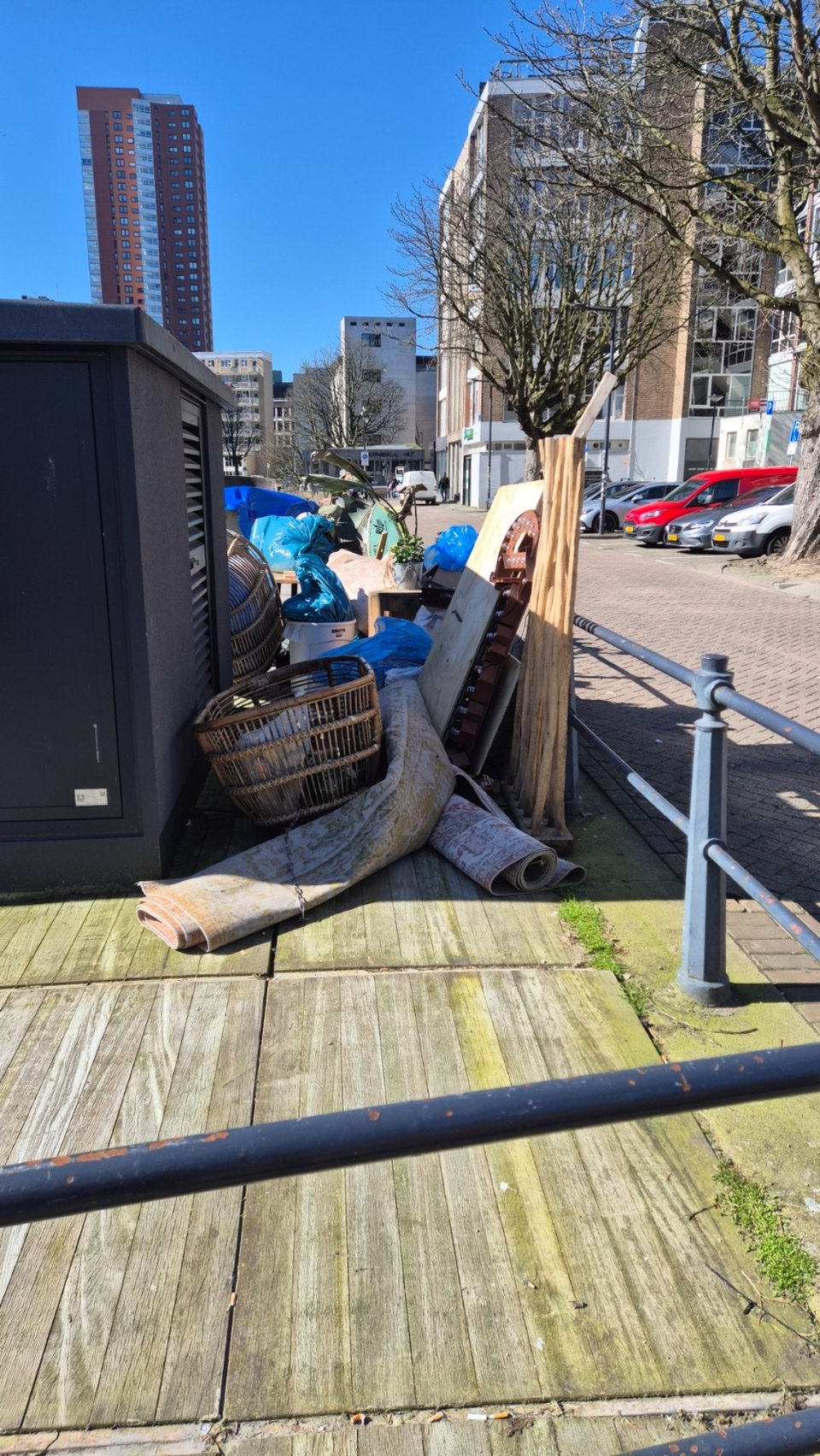 bunch of carpets wooden stools and crates assuming from a restaurant that closed down