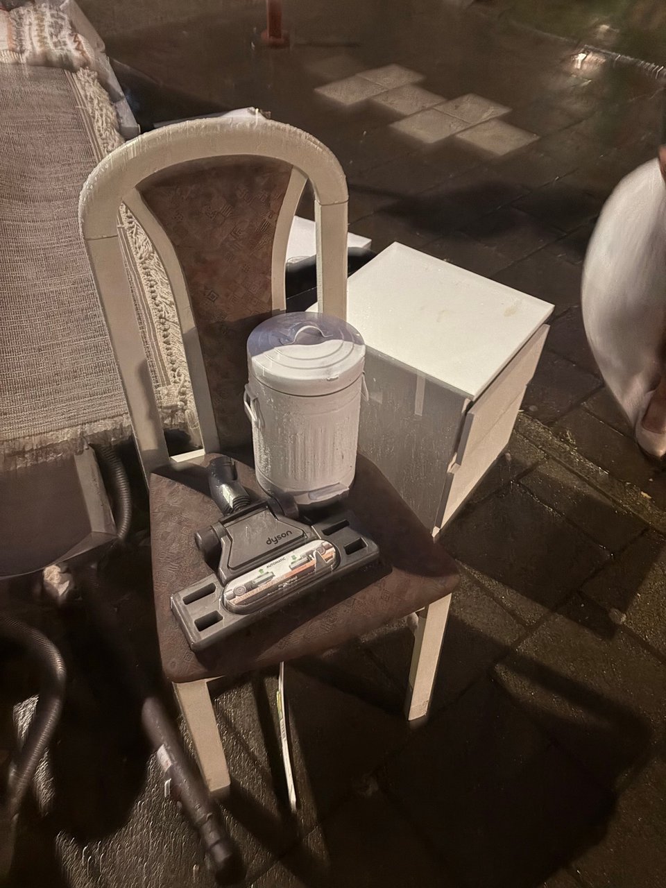 a nightstand, a chair, a mini trash can