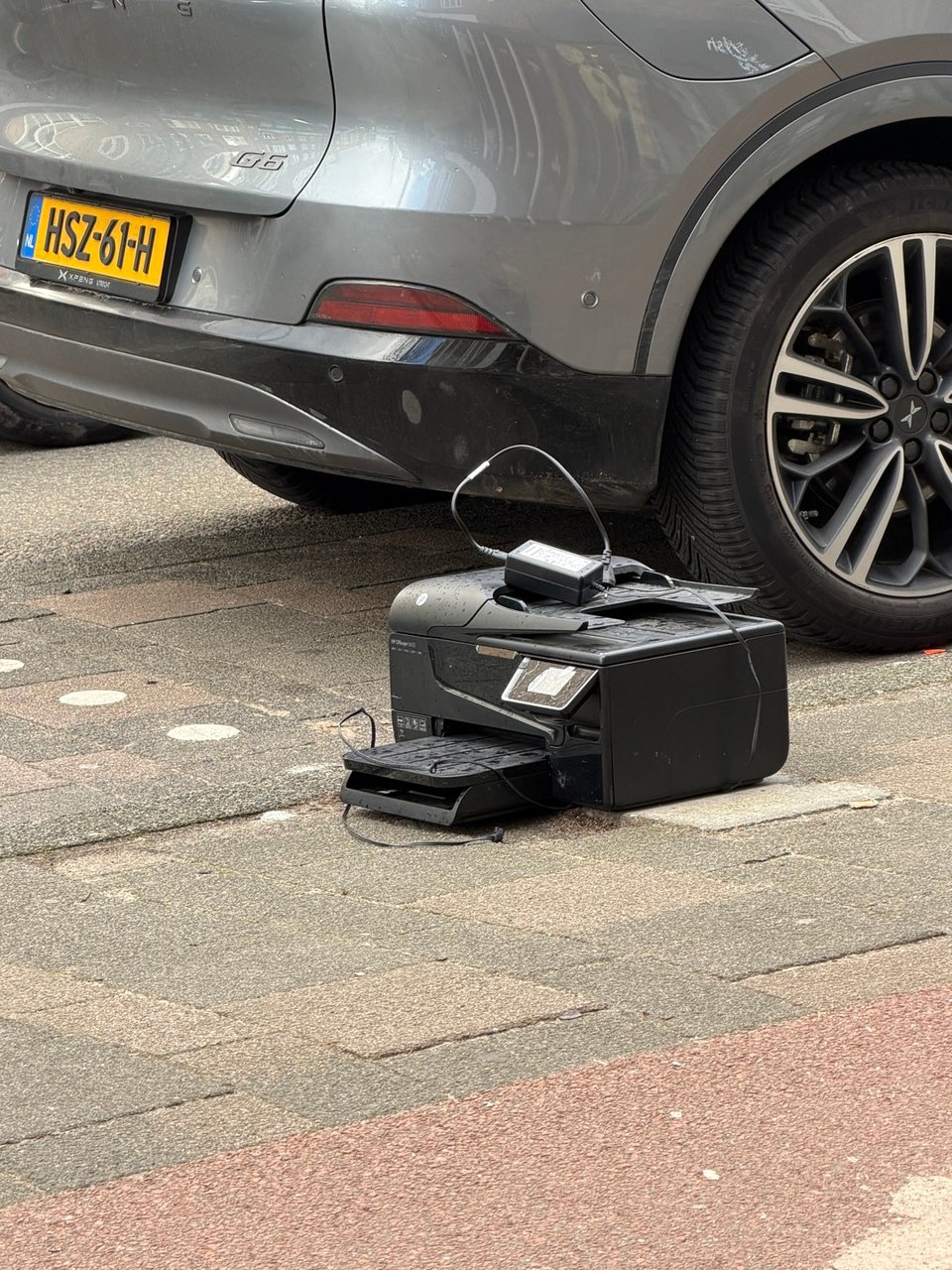 Printer on a sidewalk in front of Eyewish store