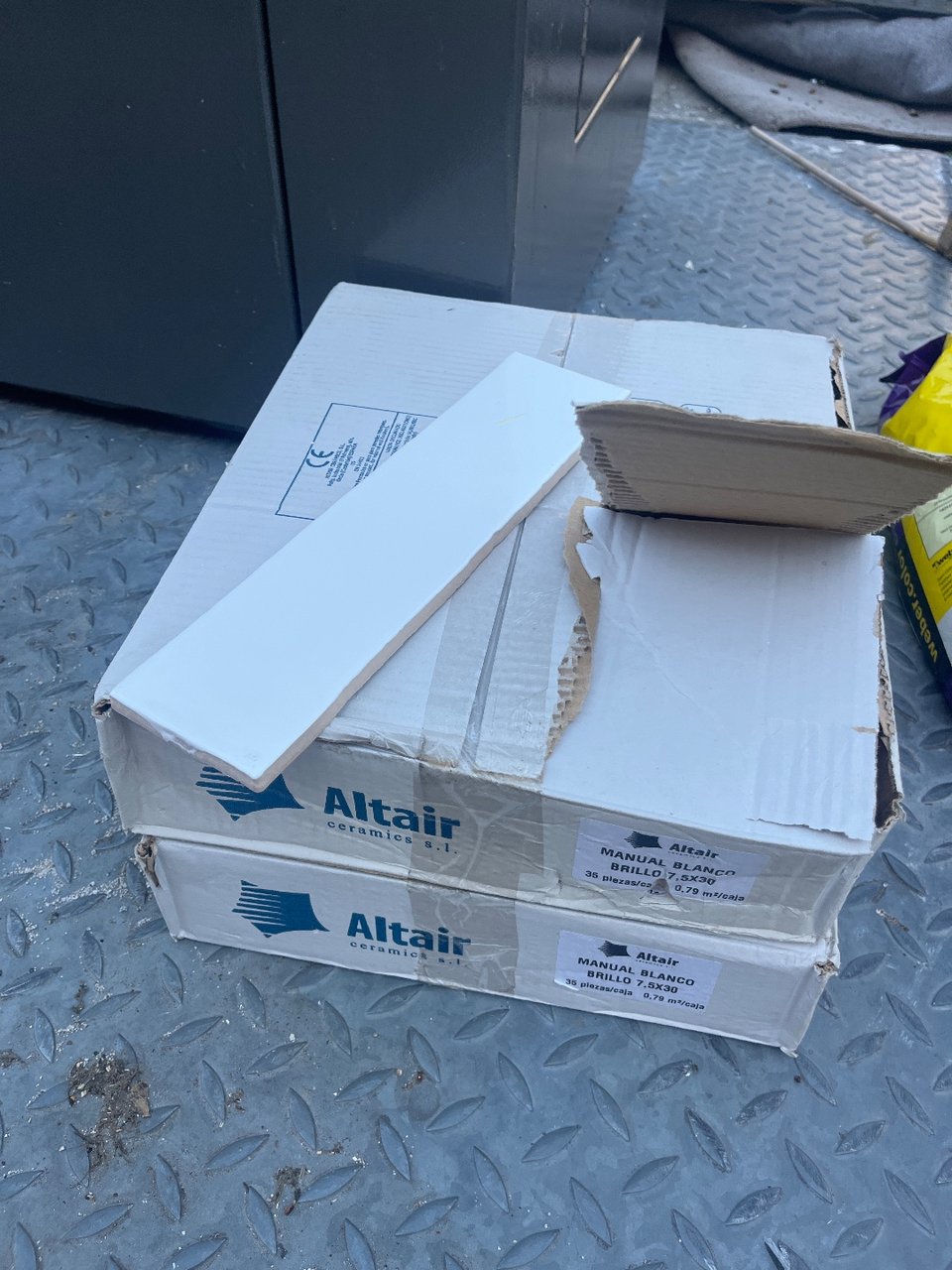 Two boxes with 35 white tiles