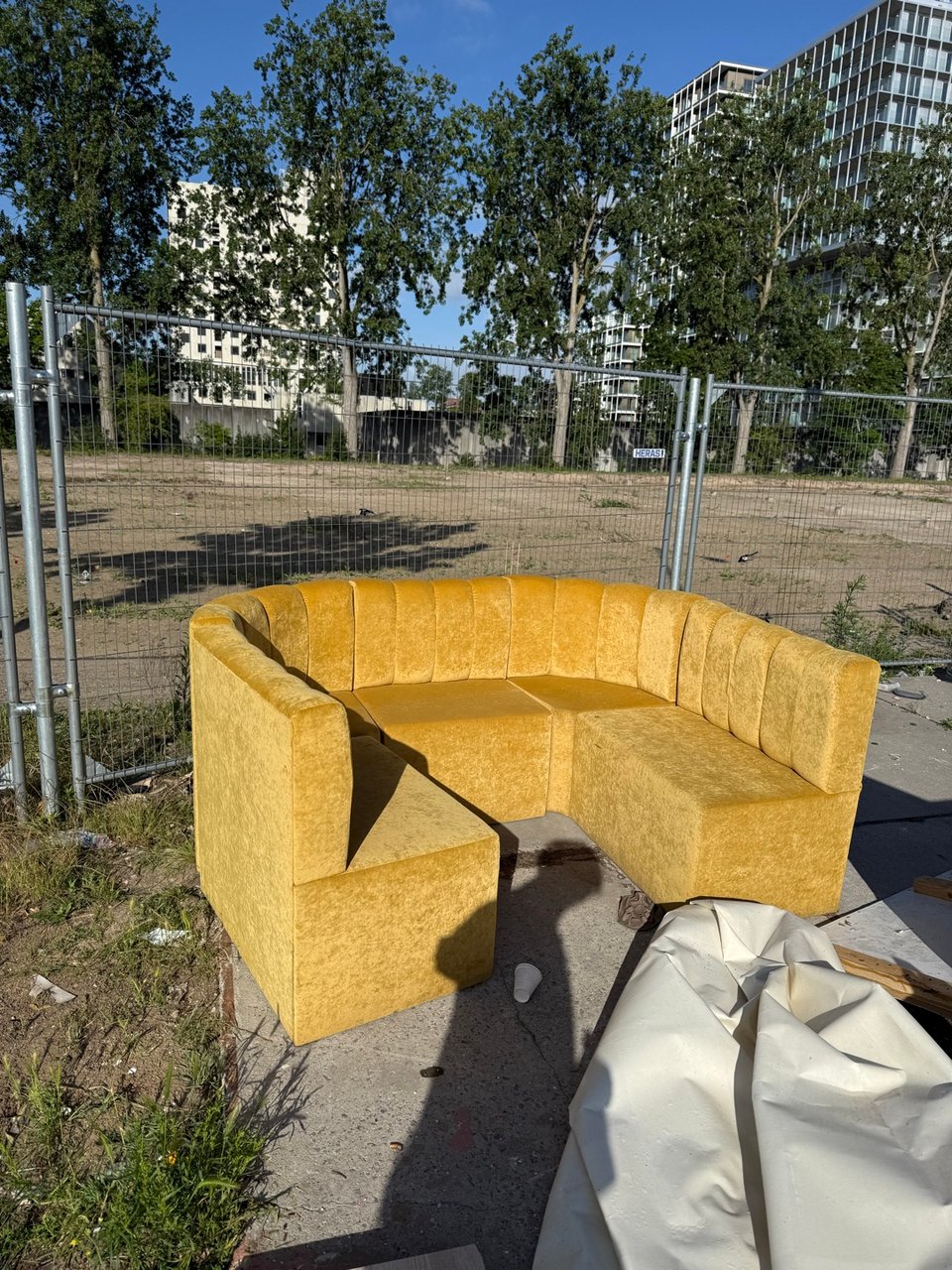 Yellow velvet couch (wet from rain)