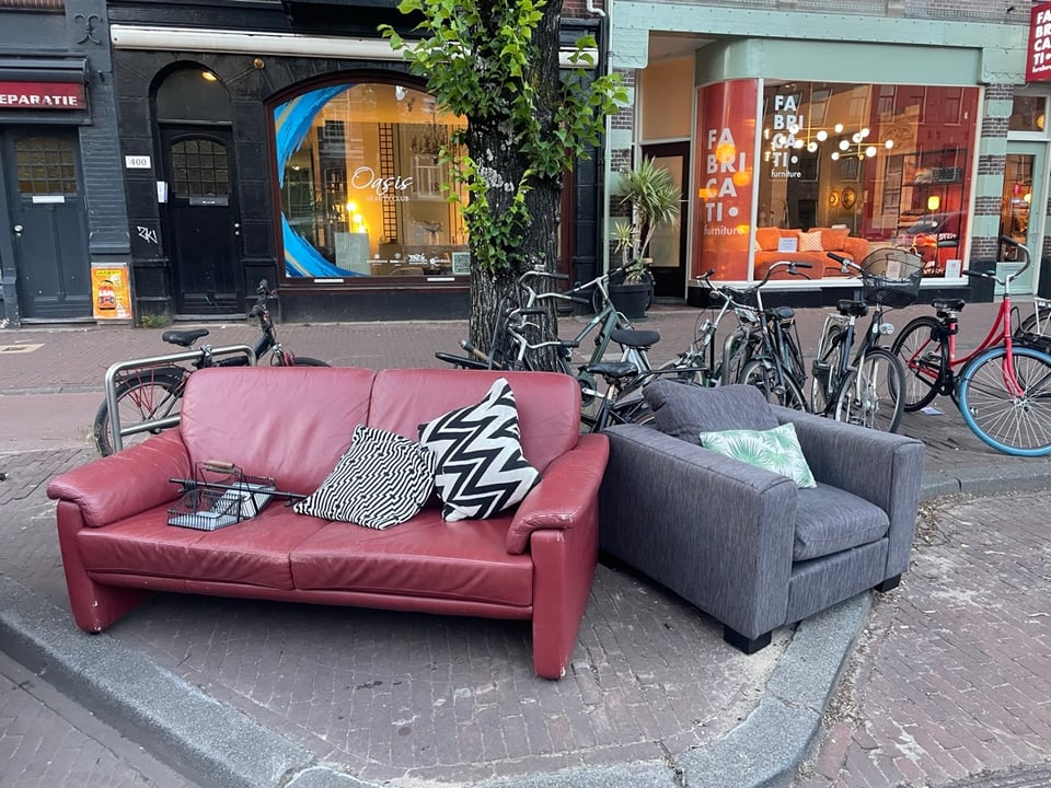 red leather couch, armchair, pillows, wall spice rack