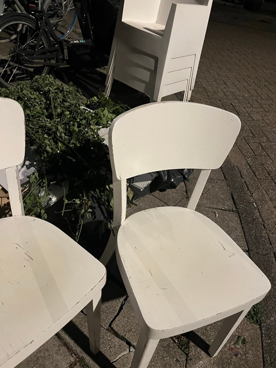 Three indoor wooden chairs and four outdoor plastic chairs, all good condition