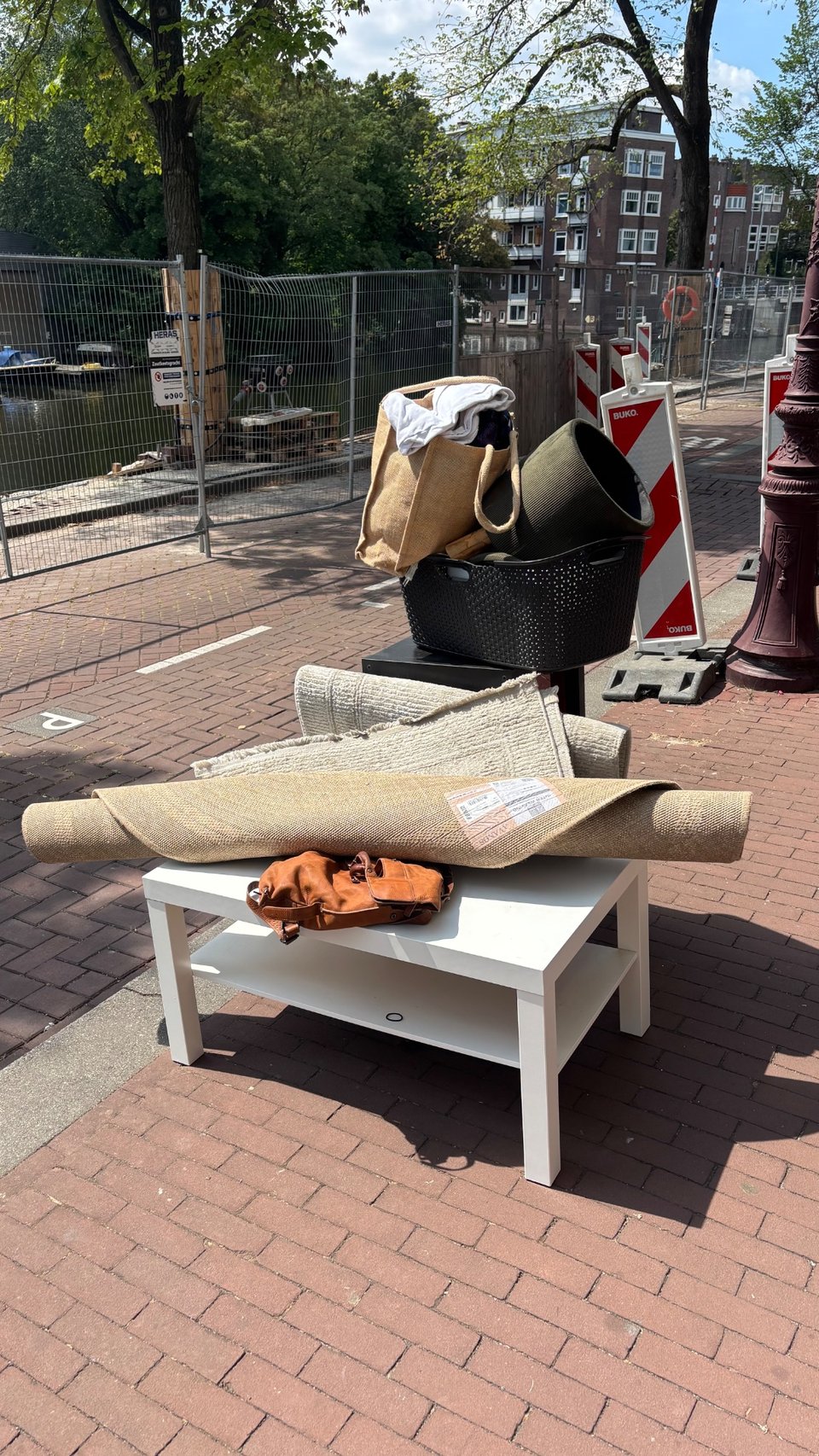 Bed and Mattress for free pick: up ring Zoutkeetsgracht 256. Round carpet, carpet, lamp, white table, box with drawers