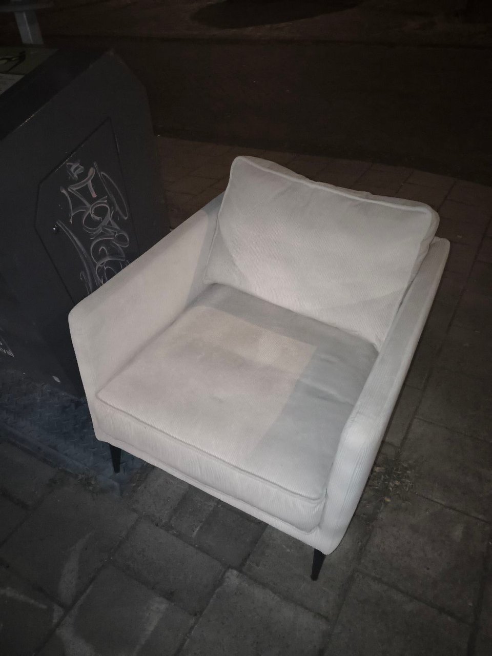 White corduroy armchair.
