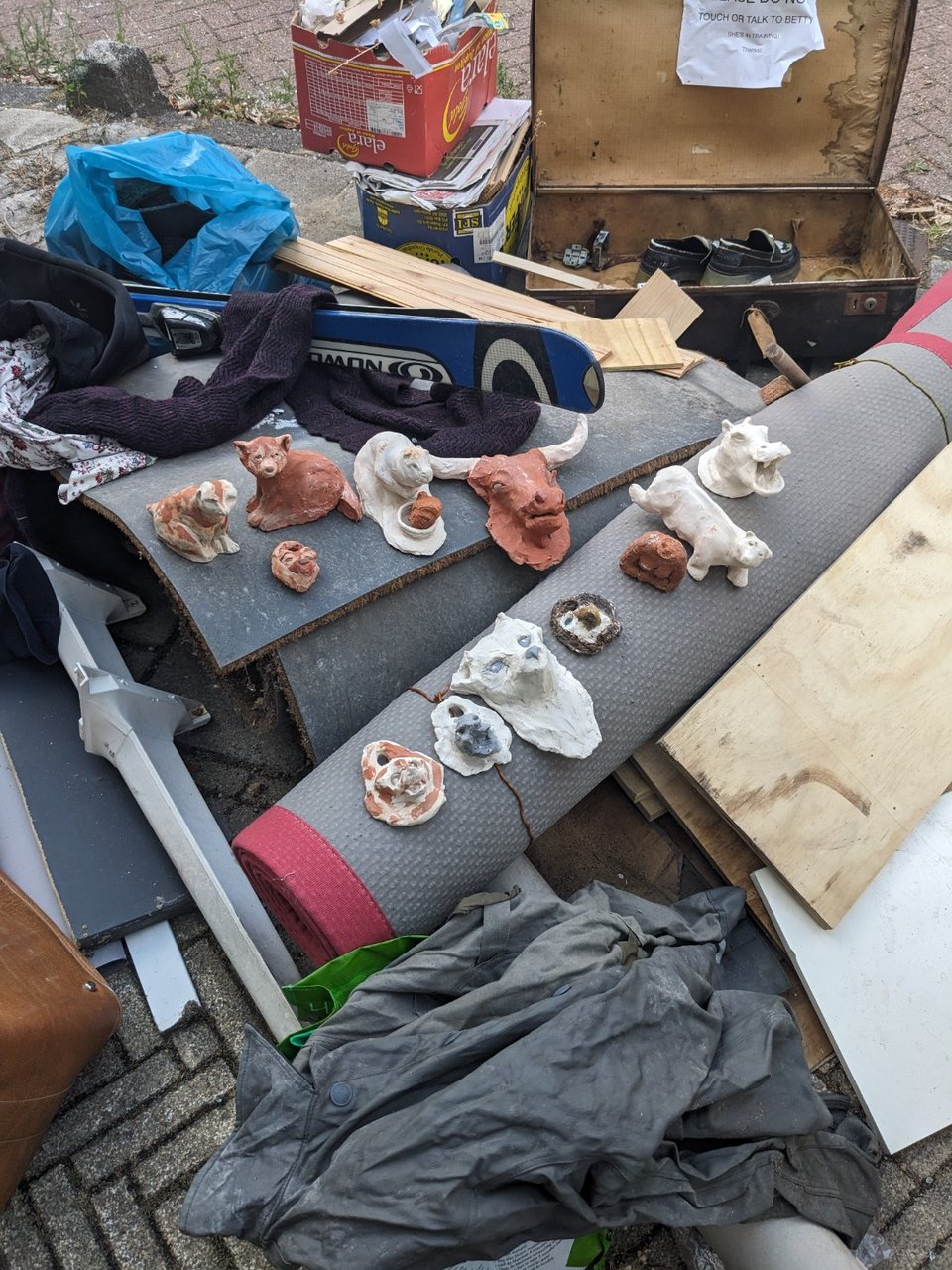Assorted stuff including a nice slab of white marble, some clay art, CDs, wooden stool