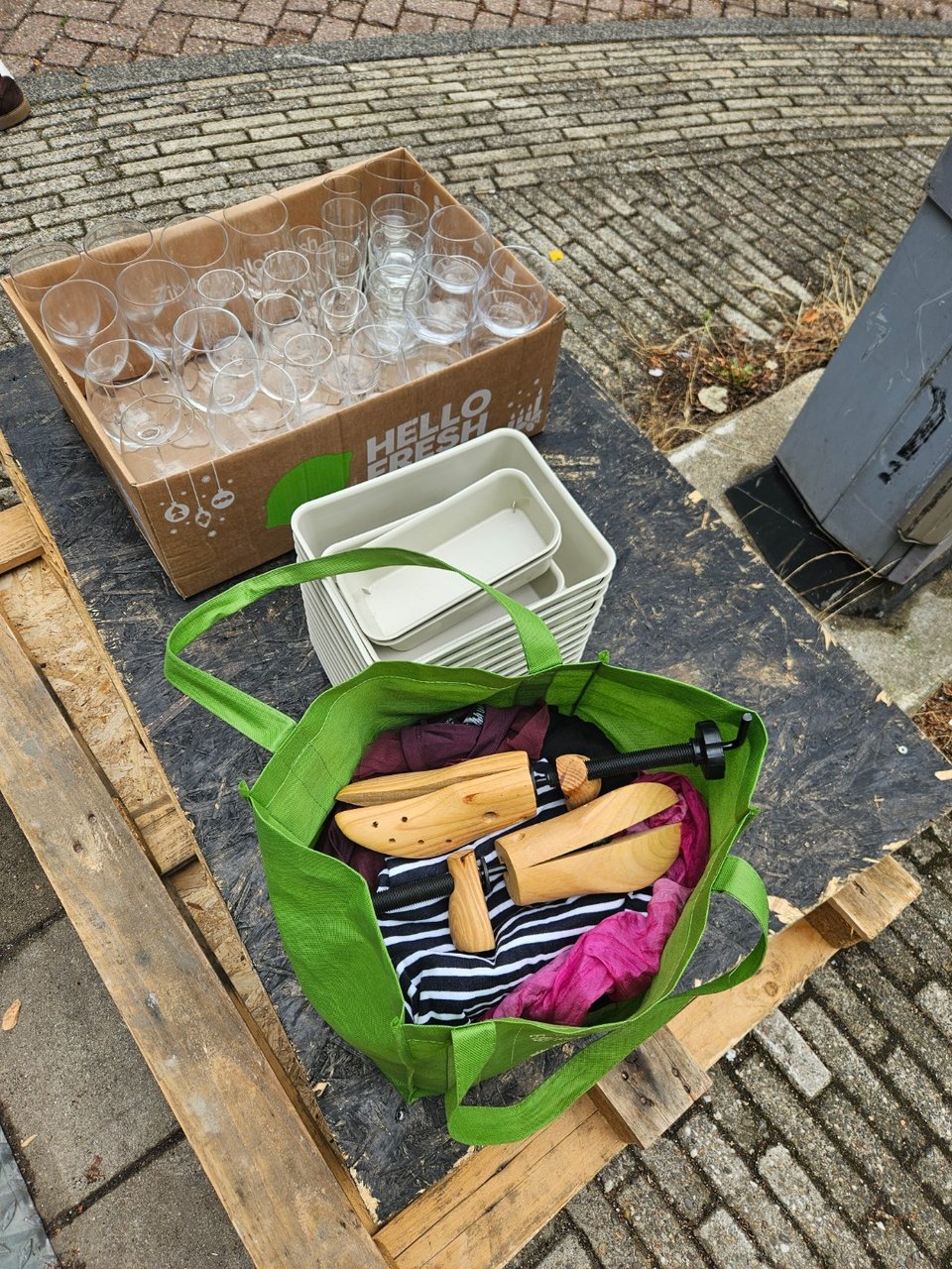 Assortment of wine glasses, IKEA storage boxes and women's clothing.