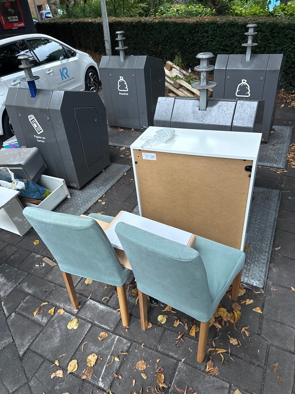 Two ikea chairs and a shoe cabinet.