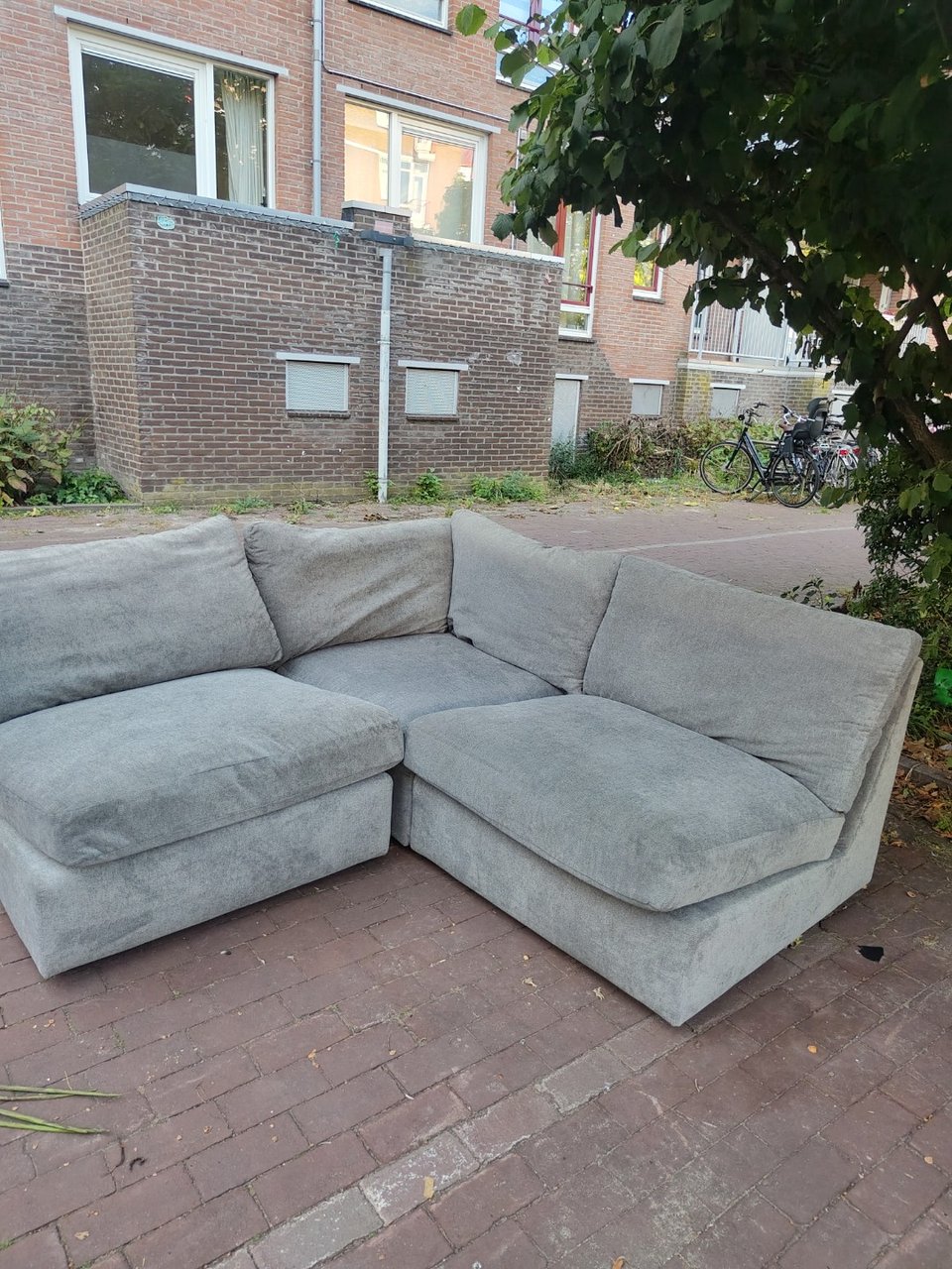 Grey modular couch, sits comfortably and without damages