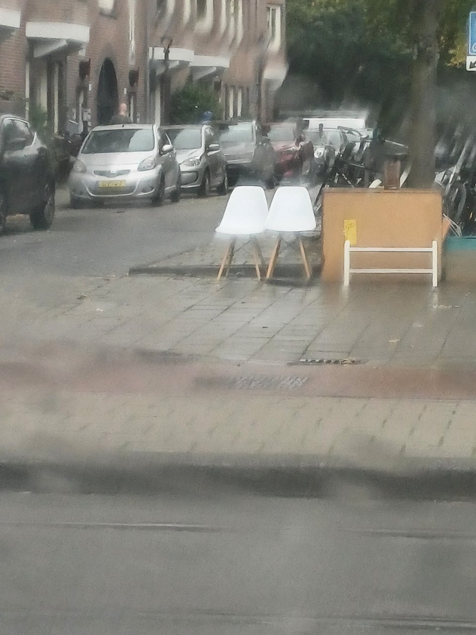 2 white plastic and wood chairs