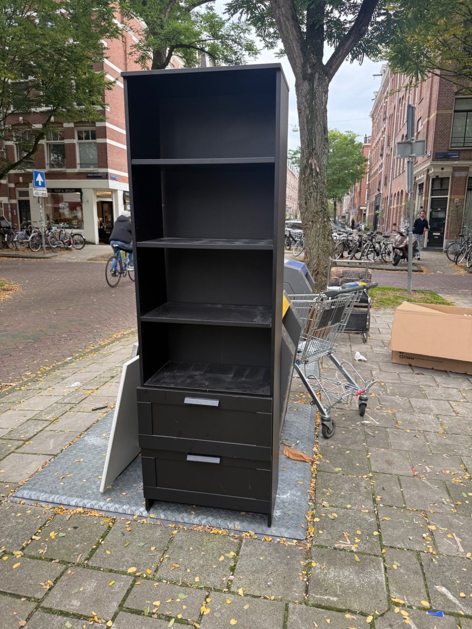 1 ikea bookcase with drawers and shelfs, 2 chairs (which you can coat again), 1 wooden side table with 3 iron legs which need a screw), 1 long white door, and more things.